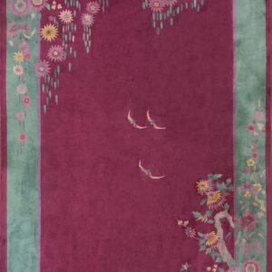 Deep magenta field rug with a wide teal floral border and three pale stylized birds.