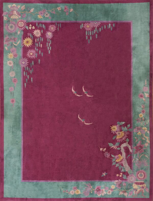 Deep magenta field rug with a wide teal floral border and three pale stylized birds.