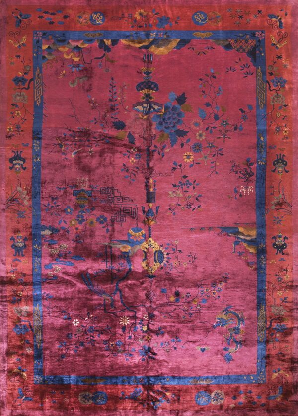 Deep magenta rug featuring a sprawling blue and yellow botanical pattern framed by contrasting red borders.