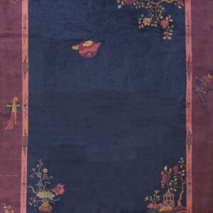 Deep indigo blue rug with a wide purple and pink border featuring stylized pictorial and floral motifs.