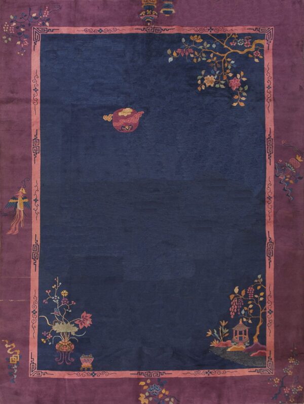Deep indigo blue rug with a wide purple and pink border featuring stylized pictorial and floral motifs.