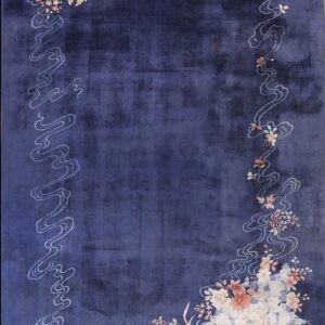 Indigo rug with an ornate border of light blue clouds and multicolored flowers in the corners.