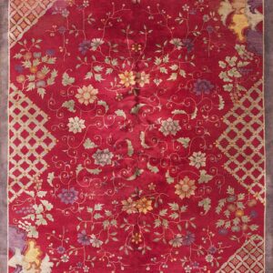 Crimson rug featuring scattered multi-colored floral and vine motifs with geometric lattice corner sections and a gray border.