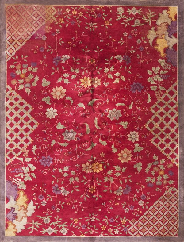 Crimson rug featuring scattered multi-colored floral and vine motifs with geometric lattice corner sections and a gray border.