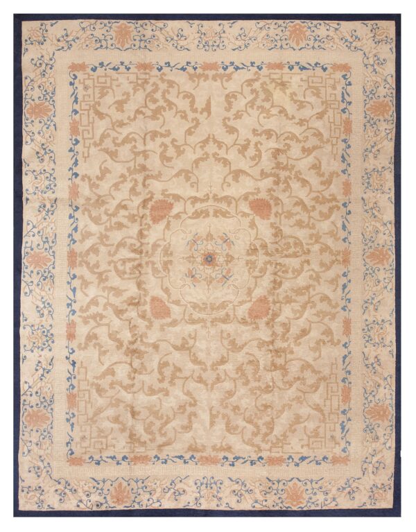 Beige rug featuring ornate camel, coral, and blue scrolling floral patterns and a dark navy edge.