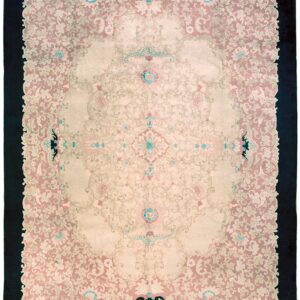 Ornamental rug featuring a pale pink and beige field with a centralized pattern and wide dark outer border.