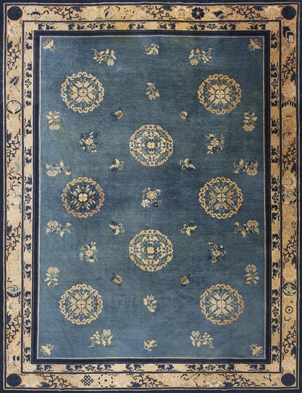Deep blue rug with an overall tan pattern of medallions, scattered flowers, and a detailed wide border.