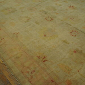 Antique Turkish Borlou Oushak rug with ivory field, large-scale floral palmettes, and soft pastel border, hand-knotted wool oversized carpet from the early 20th century