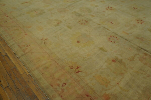 Antique turkish borlou oushak rug with ivory field, large-scale floral palmettes, and soft pastel border, hand-knotted wool oversized carpet from the early 20th century