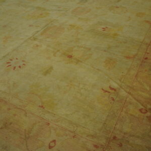 Antique Turkish Borlou Oushak rug with ivory field, large-scale floral palmettes, and soft pastel border, hand-knotted wool oversized carpet from the early 20th century