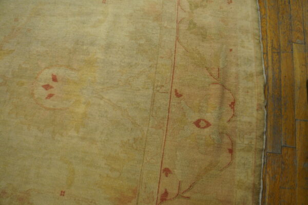 Antique turkish borlou oushak rug with ivory field, large-scale floral palmettes, and soft pastel border, hand-knotted wool oversized carpet from the early 20th century