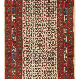 Runner rug with a cream field, dense red and dark blue geometric pattern, and wide red floral borders.
