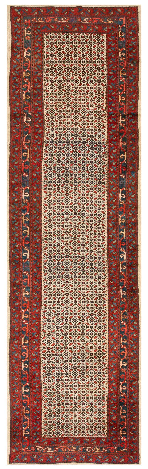 Runner rug with a cream field, dense red and dark blue geometric pattern, and wide red floral borders.