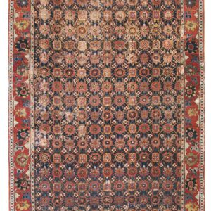 Distressed low-pile rug featuring a dense repeating geometric pattern on a navy field with thick red borders.