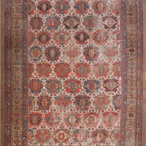 Distressed rug featuring colorful repeating geometric medallions and stylized animals on a light ivory field.