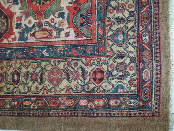 Knotted rug detail showing complex geometric designs in blue, rust, beige, and green tones.