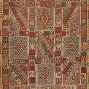 Complex flatweave rug displaying geometric squares filled with diamonds, utilizing rich reds and muted earth tones.