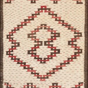 Cream flatweave rug featuring a central red and brown stepped geometric diamond pattern and a dark border.