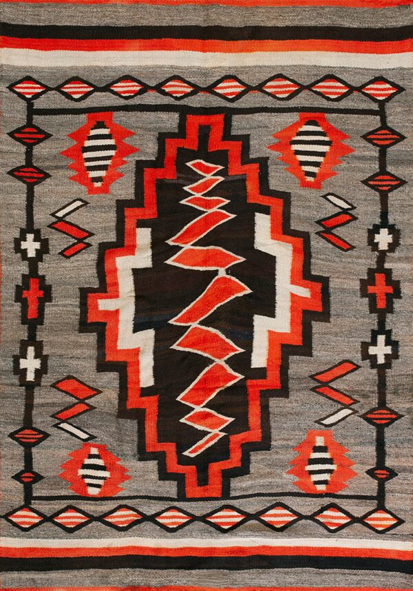 Geometric flatweave rug in gray, black, red, and white with a central serrated vertical design.