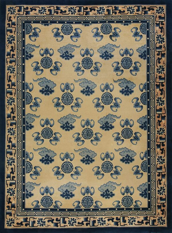 Beige rug featuring repeating dark blue cloud and bat motifs with complex borders in blue and tan.