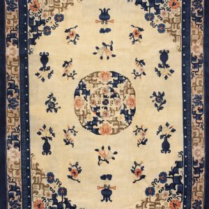 Beige rug featuring a large center medallion, navy border, and detailed blue and coral floral patterns.