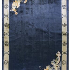 Dark blue rug with corner dragon and bird motifs contrasting a beige border with geometric symbols.