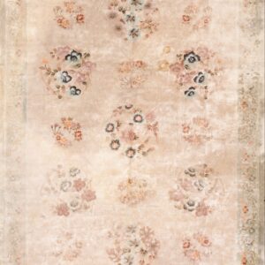 Muted beige traditional rug with an aged look, featuring large floral clusters and a detailed sage border.