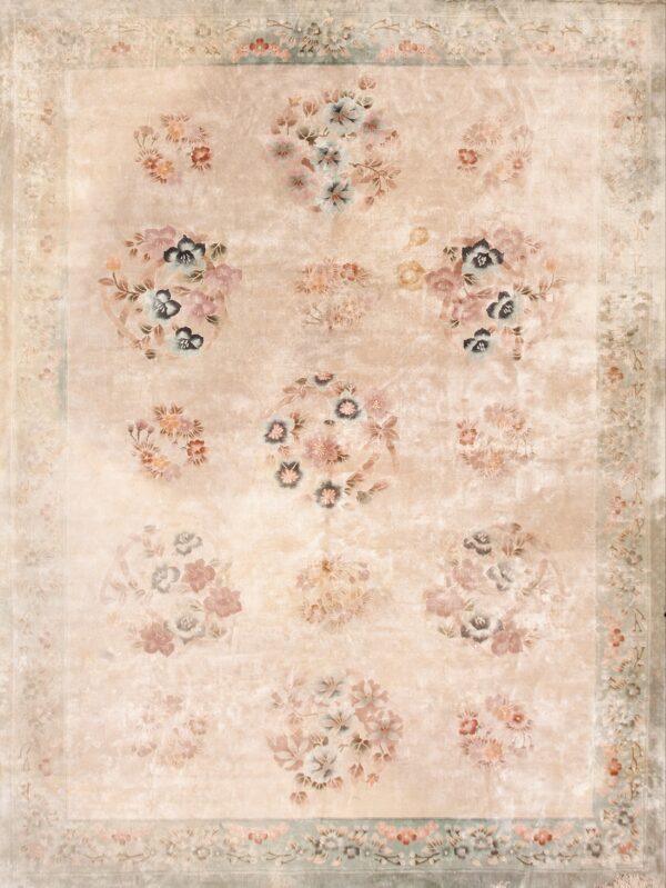 Muted beige traditional rug with an aged look, featuring large floral clusters and a detailed sage border.