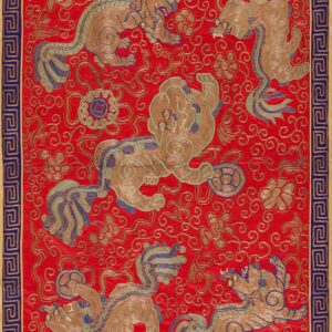 Decorative red textile with gold embroidered mythical beasts, teal accents, and a blue geometric border.