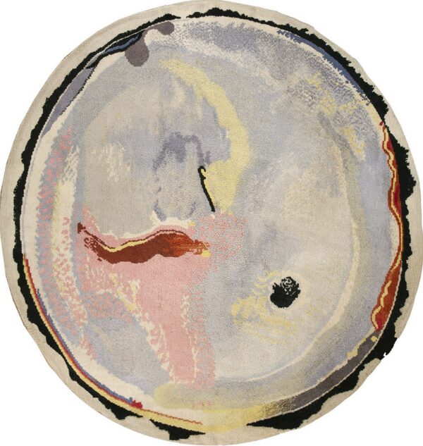 Round rug with abstract gray, cream, pink, yellow, and black swirling colors and an uneven edge.