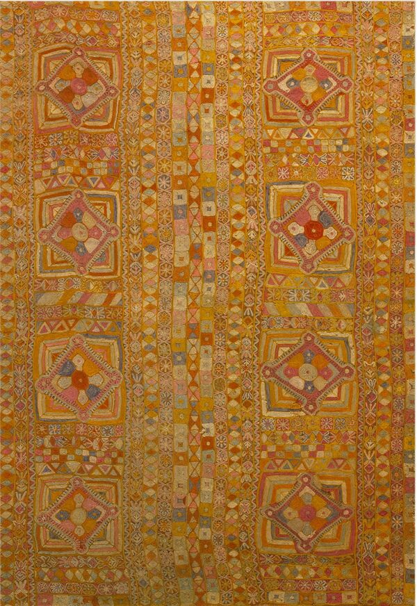 Golden yellow and orange rug with dense geometric patterns and repeating central diamond medallions.
