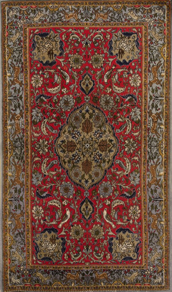 Red rug with an intricate central medallion, complex florals, and a gray border displaying running animals.