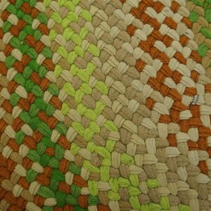 Detailed close-up of a braided rug with color sections of rust orange, lime green, and natural tan.