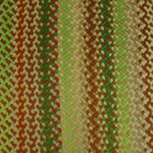 Textured braided rug in multicolored stripes of green, brown, and tan rests on distressed yellow wood floor.
