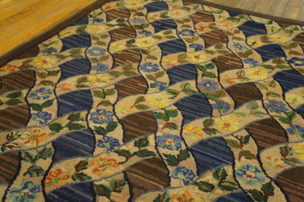 Rustic rug displaying a wavy pattern of beige florals, blue sections, and striped brown geometric shapes on a wood floor.