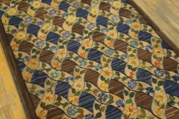 Multi-colored runner featuring a wavy floral lattice over alternating dark blue and striped brown panels on a wood floor.