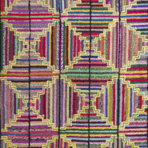 Multicolored hooked rug with a geometric log cabin pattern outlined by bright yellow zigzag borders.