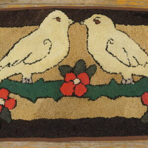Hooked rug showing two cream doves, red flowers, and green leaves on a dark ground over wood floorboards.