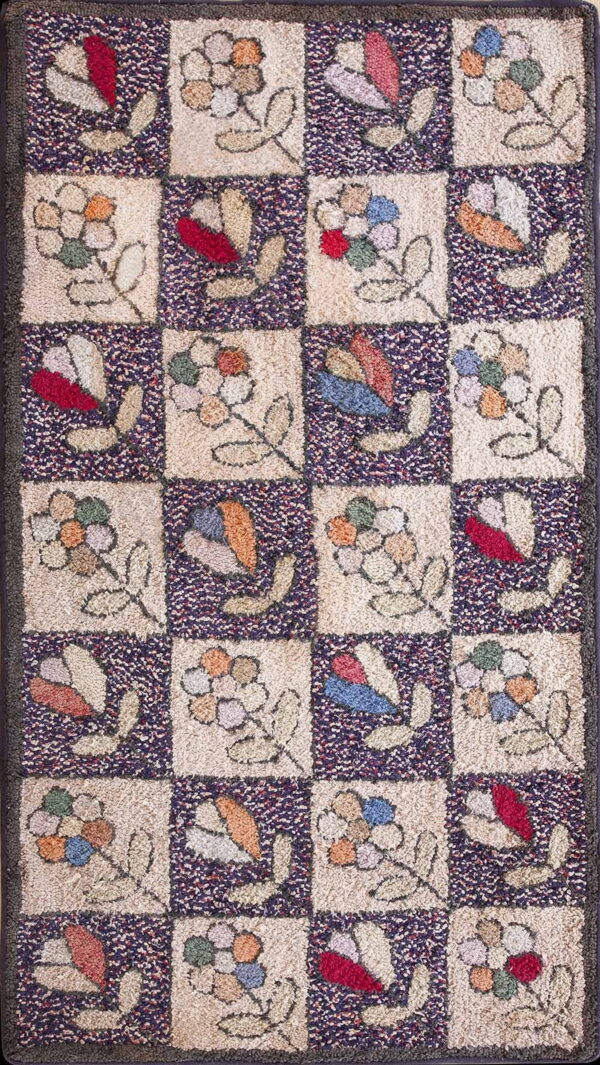 Multicolor, textured rug with a checkerboard design of stylized flowers on cream and dark speckled squares.