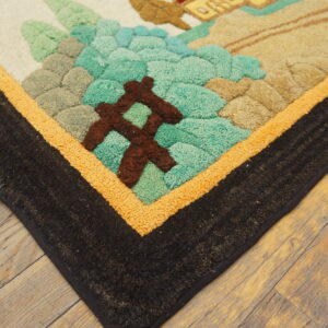 Multi-colored high-pile rug corner on rustic wood floor, featuring teal, sage, brown, and black borders.
