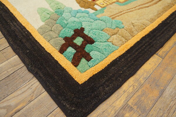 Textured high-pile rug corner displaying teal, tan, cream, and brown abstract shapes bordered by black and orange bands.