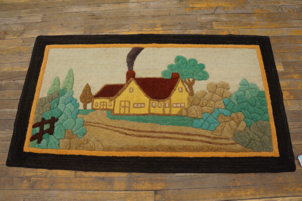 Hooked rug featuring a colorful country scene with a yellow house and green foliage on wooden floors.
