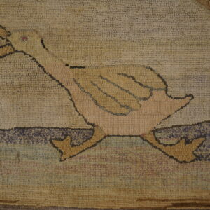 Chunky hooked rug section featuring a beige and yellow duck figure on a mottled purple and tan background.