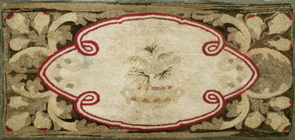 Highly textured rug displaying a cream medallion framed by red scrolls and olive green foliate designs.
