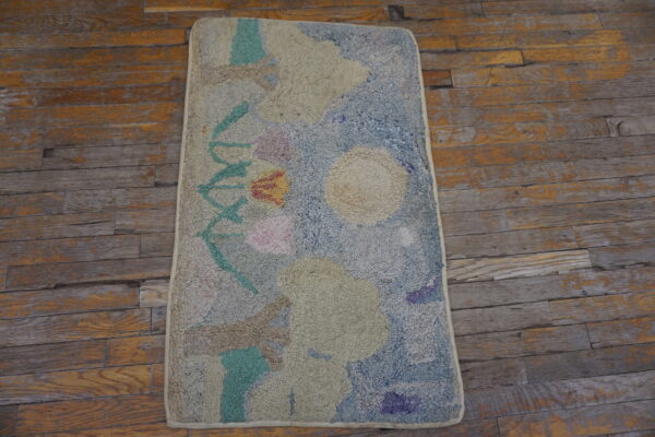 High-pile textured rug in abstract pastel blue, green, and pink on weathered wood flooring.