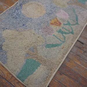 High-pile abstract rug with pale blue, beige, and pastel accents rests on weathered plank flooring.