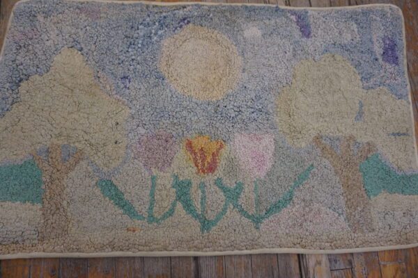 Heavily textured, pastel looped rug displaying a stylized landscape of flowers, trees, and a sun.