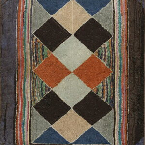 Geometric hooked rug featuring dark, tan, orange, and blue diamonds surrounded by a wide, colorful striped edge.