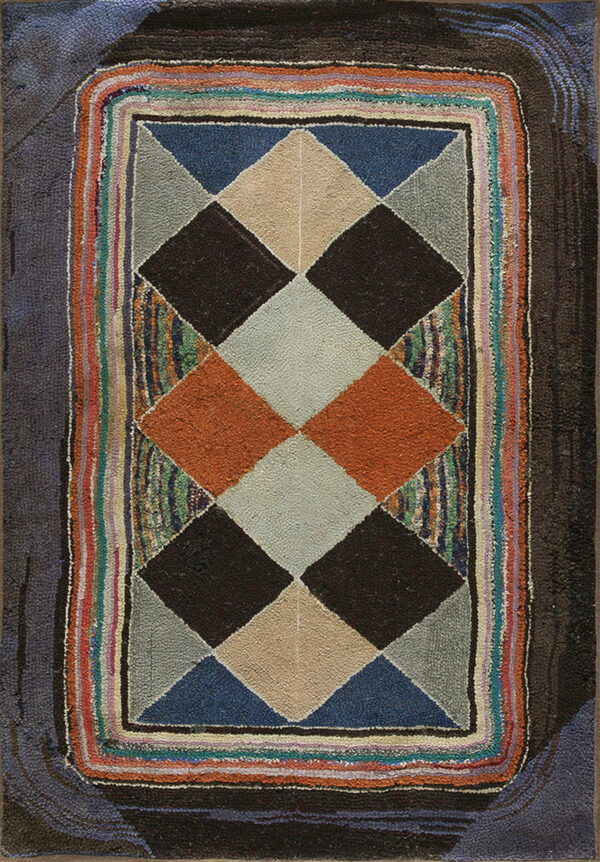 Geometric hooked rug featuring dark, tan, orange, and blue diamonds surrounded by a wide, colorful striped edge.