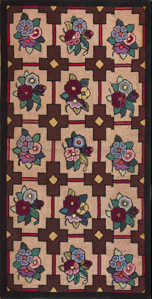 Hooked runner rug displaying colorful floral bouquets set inside a tan background and dark brown geometric grid.